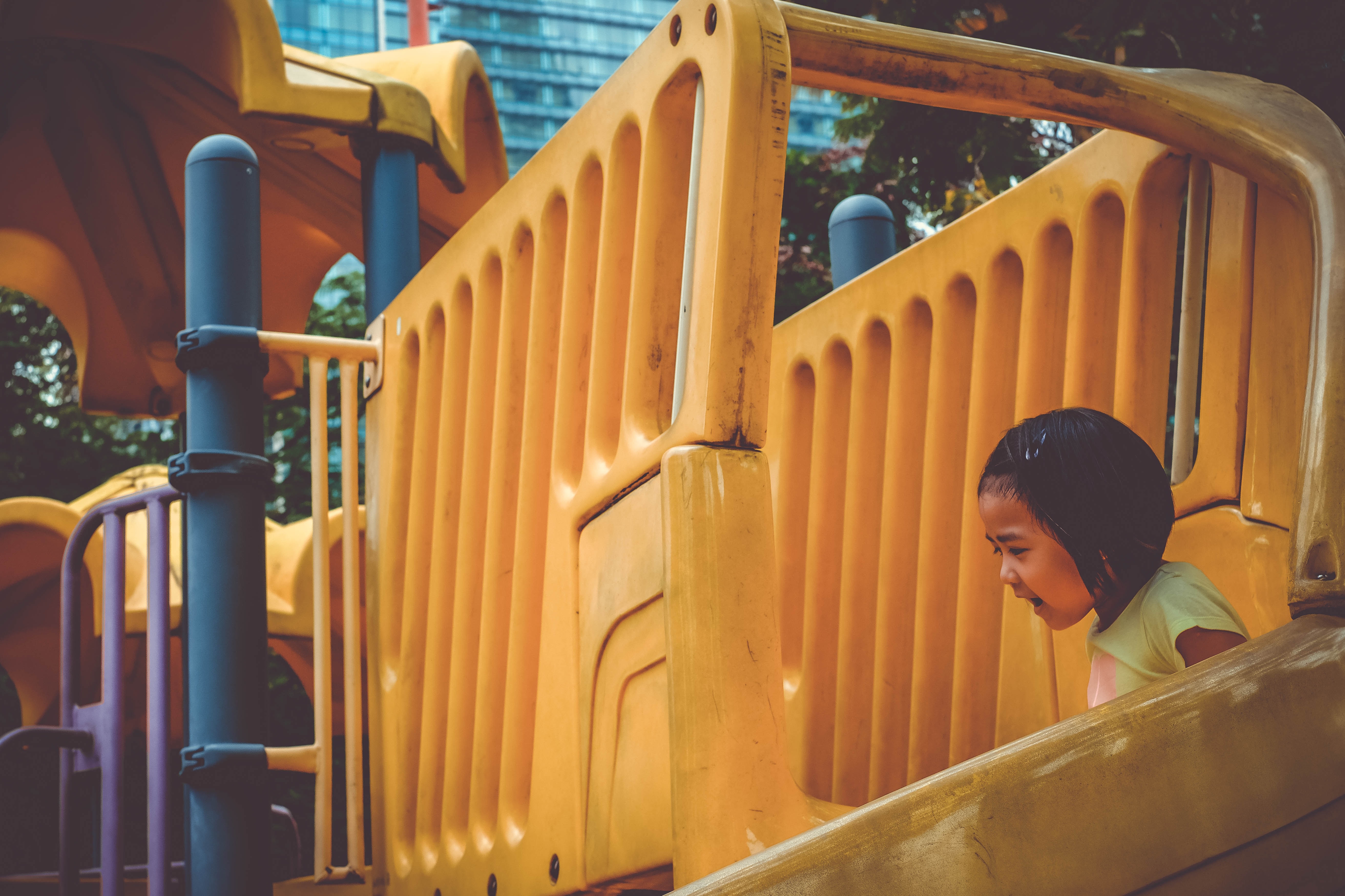 Girl Going Down Slide at Daytime Photo by Marcin Kempa on Unsplash